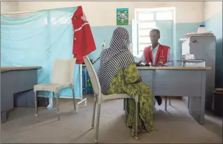  ?? Nariman El-Mofty / Associated Press ?? A Tigrayan woman who says she was gang raped by Amhara fighters speaks to surgeon and doctor-turned-refugee, Dr. Tewodros Tefera, at the Sudanese Red Crescent clinic in Hamdayet near the Sudan-Ethiopia border, eastern Sudan, on March 23. “Let the Tigray government come and help you,” she recalled them saying, even while they were raping her.