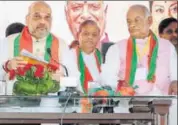  ?? PTI ?? Bharatiya Janata Party president Amit Shah with party's Rajasthan chief Madan Lal Saini (right) in Jaipur on Tuesday.