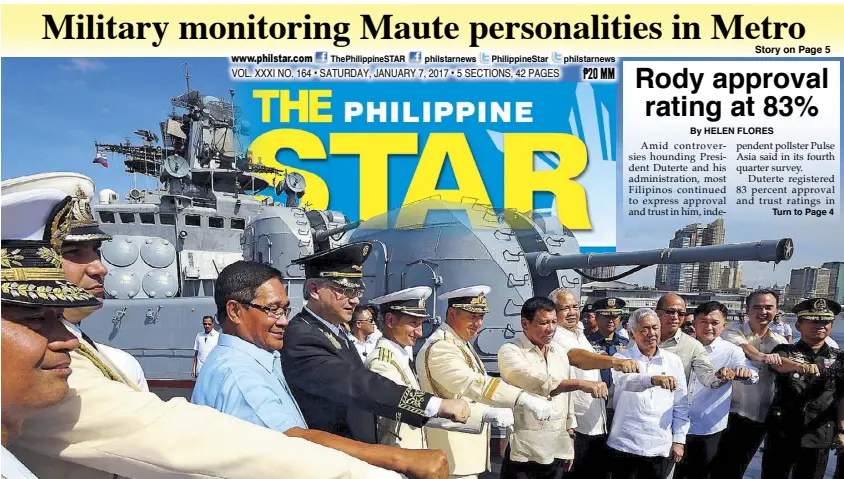  ?? KRIZ JON ROSALES ?? President Duterte leads the flashing of his signature fist gesture during a tour of the visiting Russian anti-submarine ship Admiral Tributs at the South Harbor in Manila yesterday. He was joined by Rear Admiral Eduard Mikhailov, deputy commander of...