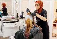  ?? Reuters ?? Huda Quhshi dyes the hair of a Muslim woman ahead of the Eid Al Fitr holiday in Brooklyn. —