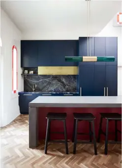  ??  ?? Dining area A pendant light by Articolo hangs above the ‘Moon’ dining table by Space Copenhagen and ‘Beetle’ chairs by GamFratesi, all for Gubi
Kitchen This space is a rich marriage of materials, from the blue Sodalite countertop and splashback to the concrete island, navy blue bespoke cabinetry and brass details. ‘Sketch Root’ bar stools from Globe West allow guests to perch beneath the pendant light from Articolo