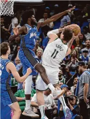  ?? Stephen M. Dowell/tribune News Service ?? Orlando’s Jonathan Isaac (1) blocks Brook Lopez as the Magic clinched the Southeast Division on Sunday.