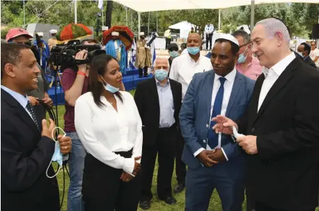  ?? (Amos Ben Gershom/GPO) ?? WITH DEPUTY Public Security Minister Gadi Yevarkan and Prime Minister Benjamin Netanyahu at the memorial ceremony for Ethiopian Jews who died in Sudan on their journey to Israel, one of her first public events as a minister.
