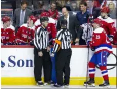  ?? AL DRAGO — THE ASSOCIATED PRESS ?? Capitals coach Todd Reirden speaks with officials after Tom Wilson left the ice during the second period against the Devils on Friday in Washington.