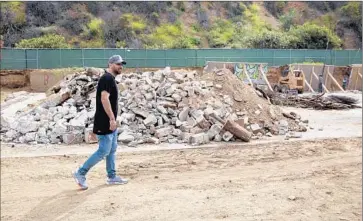  ?? Brian van der Brug Los Angeles Times ?? NEIMA KHAILA says his love of Runyon Canyon Park drove him to donate more than $250,000 to fix “an eyesore” there. Above, Khaila at the site of a branded basketball court under constructi­on at the park.