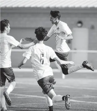  ?? DENIS POROY PHOTOS ?? Patrick Henry’s Julian Garcia (right) celebrates his game-winning overtime goal with teammates.