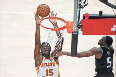  ?? AP-Brynn anderson ?? Atlanta Hawks’ Clint Capela (15) shoots against Sacramento Kings guard De’Aaron Fox (5) during the second half of an NBA basketball game in Atlanta on Saturday.