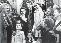  ?? AP ?? George Bailey (Jimmy Stewart), center, holds Zuzu (6-year-old Karolyn Grimes), in the 1946 Frank Capra classic “It’s a Wonderful Life.”