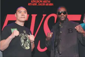  ?? ACTION IMAGES VIA REUTERS ?? Zhang Zhilei (left) and Deontay Wilder pose during a news conference in London on Monday. Wilder has hinted his fight against Zhang, on the undercard of Dmitry Bivol and Artur Beterbiev’s undisputed light heavyweigh­t world title fight in Saudi Arabia on June 1, could be his last.