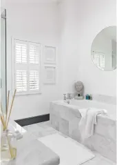  ??  ?? BATHROOM Discreet white window shutters keep this scheme simple and the lines clean. For window shutters like these one, try Shutters Direct, from £54 for a minimum size of 50sq cm. Statuario marble tiles, £177.32sq m, topps tiles, are similar