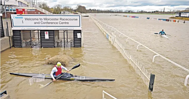  ??  ?? Members of Worcester Canoe Club kayak on Worcester Racecourse, invaded by the River Severn, after a third consecutiv­e weekend of stormy weather caused widespread floods and disruption across the country