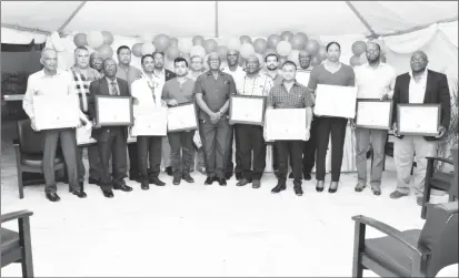  ??  ?? Minister of Citizenshi­p, Winston Felix (centre) with some of those who were recognized. (Ministry of the Presidency photo)