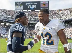  ?? Steph Chambers/Post-Gazette ?? Penn State safety Lamont Wade, left, and Pitt defensive back Paris Ford greet one another after the game Saturday in University Park.