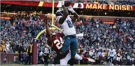  ?? ALEX BRANDON - THE ASSOCIATED PRESS ?? Eagles wide receiver Greg Ward, right, outleaps Washington’s Josh Norman to pull in the winning touchdown on Sunday.