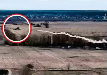  ?? ?? MENACE: The helicopter, circled, flies low over a field – as a Ukrainian rocket flies towards it