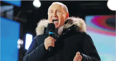  ?? AP ?? Russian President Vladimir Putin speaks during a rally near the Kremlin in Moscow on Sunday. An exit poll suggests that Putin won a fourth term as Russia’s president.