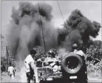  ?? GHISLAIN BELLORGET — THE ASSOCIATED PRESS ?? Smoke billows up from air strikes conducted by U.S. Air Force F-100 fighterbom­bers flying in direct support of Cambodian troops attempting to retake the road junction town of Skuon on Aug. 7, 1970.