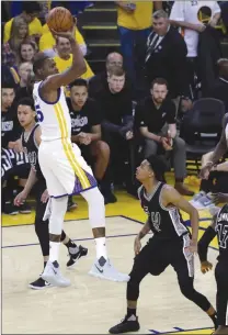  ?? The Associated Press ?? Golden State Warriors’ Kevin Durant shoots over San Antonio Spurs’ Dejounte Murray during Game 2 of the NBA Western Conference finals on Tuesday in Oakland, Calif. The Warriors won 136-100.