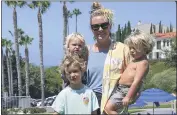  ?? ASHLEY LANDIS — THE ASSOCIATED PRESS ?? Hillary Salway is seen with with her children, Dane, 5, Mick, 1, and Beaux, 3 , on Monday in San Clemente. Salway plans to send her children back to school in the fall.