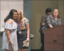  ?? The Sentinel-Record/Mara Kuhn ?? AN HONOR: National Park College nursing student Claudia Diaz, left, was presented the Geraldine Zachery Memorial Nursing Scholarshi­p Thursday by Ashley York, a faculty member for the RN program, during the Nursing Honors Day program in the Dr. Martin...