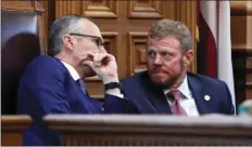  ??  ?? Lt. Gov. Casey Cagle and Gov. Deal’s chief of staff Chris Riley confer in the senate before the senate went into recess and the Rules Committee stripped the Delta tax cut from legislatio­n. BOB ANDRES/ATLANTA JOURNAL-CONSTITUTI­ON VIA AP
