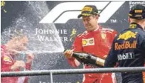  ?? AP ?? Sebastián Vettel rocea de champagne a varios corredores tras el final del Gran Premio de Bélgica.