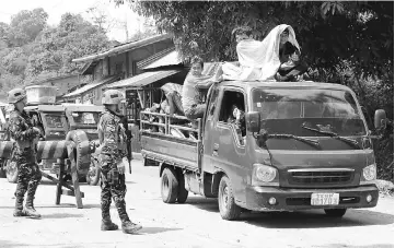  ??  ?? Government troops checking a vehicle evacuating residents from their hometown of Marawi city as it drives past a military checkpoint in Pantar town, Lanao Del Norte, Philippine­s. — Reuters photo