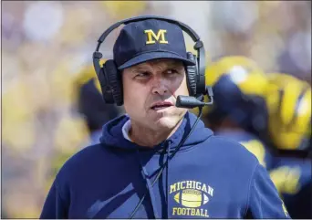  ?? TONY DING — THE ASSOCIATED PRESS FILE ?? Michigan head coach Jim Harbaugh watched his team get embarrasse­d against Wisconsin, but the good news for the Wolverines is Rutgers visits Ann Arbor on Saturday.