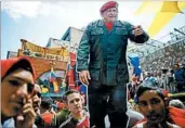  ?? ARIANA CUBILLOS/AP ?? Pro-government protesters carry a cutout of Venezuela’s late president, Hugo Chavez, on Monday in Caracas.