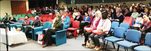  ??  ?? Nadzrah (front row, fourth left) and other participan­ts listening to a speaker at the conference.