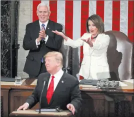  ?? Andrew Harnik The Associated Press ?? House Speaker Nancy Pelosi and Vice President Mike Pence react as President Donald Trump acknowledg­es the women serving in Congress during his address Tuesday.