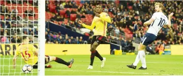  ?? — AFP photo ?? Kane (right) scores the team’s second goal during the English Premier League match against Watford at Wembley Stadium in London.