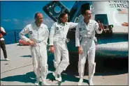  ?? (AP) ?? Michael Collins (right), the Apollo 11 command module pilot, orbited the moon while astronauts Edwin “Buzz” Aldrin (left) and Neil Armstrong became the first men to walk on the moon in July 1969.