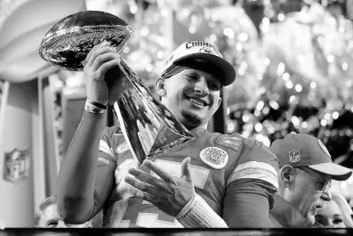  ?? AP ?? Kansas City Chiefs quarterbac­k Patrick Mahomes celebrates with the trophy after the team’s win in overtime during the NFL Super Bowl 58 football game against the San Francisco 49ers on Sunday in Las Vegas. The Chiefs won 25-22.