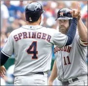  ?? AP/CHRIS YOUNG ?? Houston catcher Evan Gattis (right) is congratula­ted by right fielder George Springer after Gattis’ three-run home run in the sixth inning of Sunday’s 19-1 blowout of Toronto.