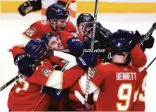  ?? Lynne Sladky / Associated Press ?? Panthers defenseman Aaron Ekblad (left) celebrates with teammates after scoring the game-winning goal in overtime.