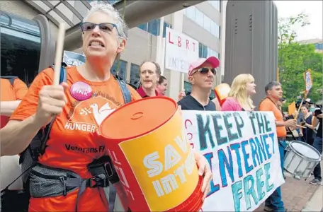  ?? Karen Bleier AFP/Getty Images ?? PROTESTERS hold a rally in 2014 to support net neutrality. That year, a court again sided with the telecom industry over the FCC rules.