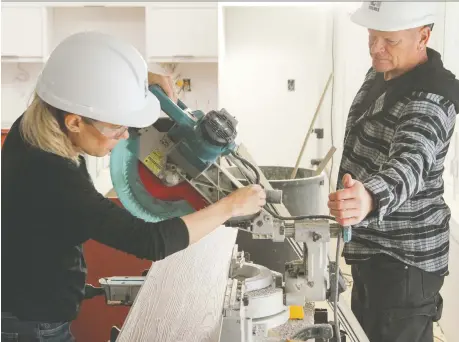  ?? THE HOLMES GROUP ?? Sherry Holmes and Mike Holmes work on the set of Holmes Family Effect. Mike Holmes says his daughter “shares the same passion I have for the skilled trades.”