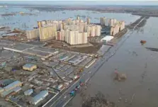  ?? — Reuters file photo ?? A drone view shows a flooded area around the Dubki residentia­l complex in Orenburg, Russia.