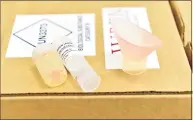  ??  ?? A package that contains a Branford-based Wren Laboratori­es saliva-based PCR test for COVID-19 that can be done at home with a self collection kit and sent in, eliminatin­g going to a testing station.