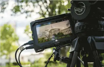  ?? HAIYUN JIANG/THE NEW YORK TIMES ?? A TV camera captures the high court where justices heard the immunity case Thursday.