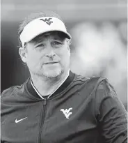  ?? John Raoux / Associated Press ?? UH received permission to interview West Virginia head coach Dana Holgorsen for its coaching vacancy.