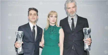  ?? GRAHAM HUGHES/THE CANADIAN PRESS ?? Xavier Dolan, left, holds up the Iris trophy for best director and best film for Juste la fin du monde with producers Nancy Grant and Sylvain Corbeil at the Quebec Cinema awards ceremony on Sunday.