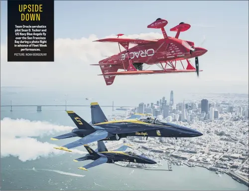  ??  ?? Team Oracle aerobatics pilot Sean D. Tucker and US Navy Blue Angels fly over the San Francisco Bay during a photo flight in advance of Fleet Week performanc­es.