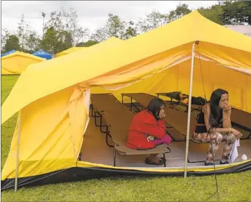  ?? Raul Arboleda AFP/Getty Images ?? VENEZUELAN­S who fled the crisis in their home country rest at a shelter in Bogota, the first such camp Colombian officials have establishe­d in the capital. It is modeled after a French shelter for Syrian refugees.