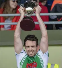  ??  ?? Na Gaeil captain Eoin Doody lifts the County Premier Junior Club Championsh­ip cup after their county final win last May
