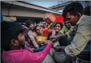  ?? ?? People living in temporary shelter jostle for drinking water Sept. 29 from a municipali­ty water tanker after they evacuated.