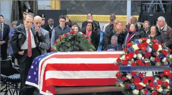  ?? MANUEL BALCE CENETA/AP ?? Former Sen. Bob Dole is helped up to the flag-draped casket in the Capitol Rotunda.