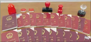  ?? — CANADA BORDER SERVICES AGENCY ?? Chinese passports and stamps seized by Canada Border Services in an investigat­ion involving an unlicensed immigratio­n consulting business owned by Xun ‘Sunny’ Wang.