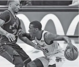  ?? CHRIS O'MEARA AP ?? Miami Heat guard Kendrick Nunn pushes off Toronto Raptors guard Norman Powell as he drives up the court during the second half Wednesday.